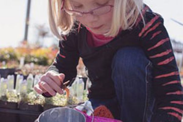 child playing at plant nursery