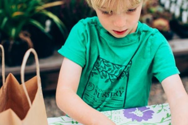 child creates art during kids class at plant nursery